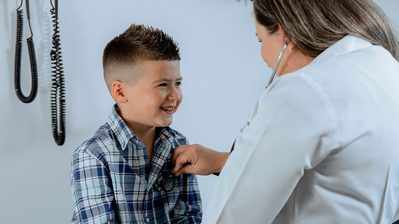 pediatrician using a stethoscope