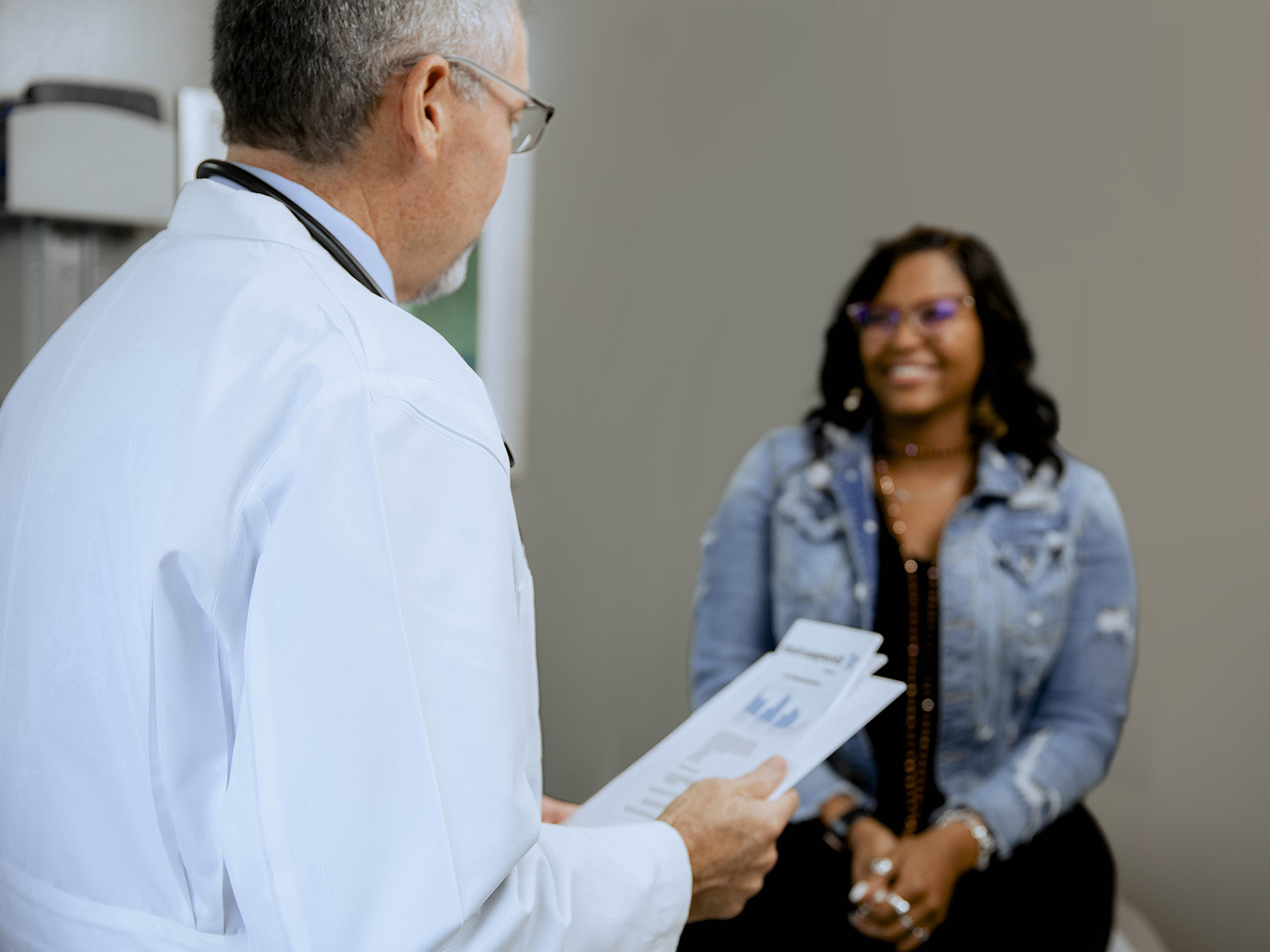 Texas Tech physician in a consultation with a smiling female patient.