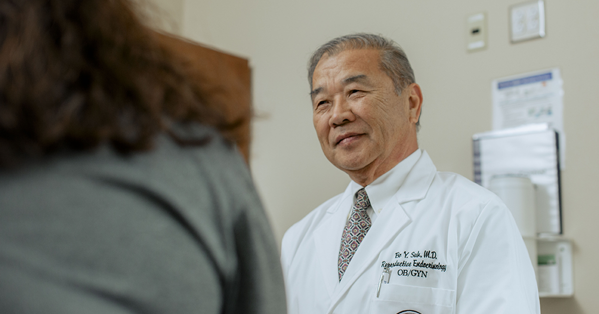 Dr. Bo Y Suh, M.D. consults with a patient