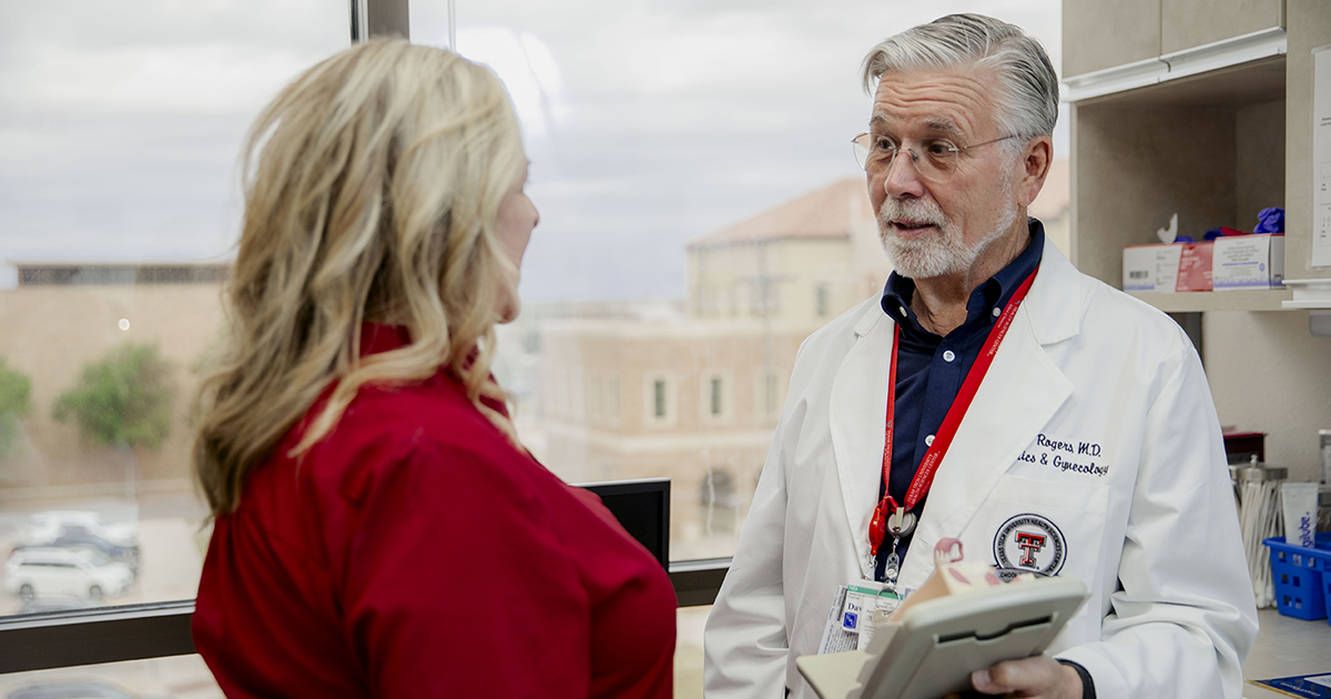 Dr. Rogers consults with a female patient.