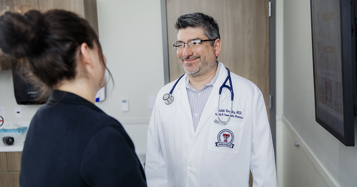 Dr. Rosalez consults with a female patient.