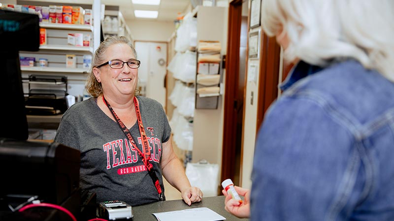 Amarillo pharmacist assisting a patient in the pharmacy