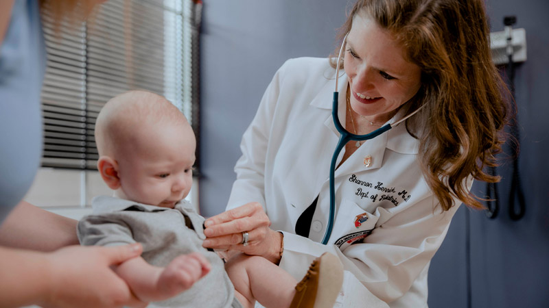 Provider using stethoscope on baby pediatric patient
