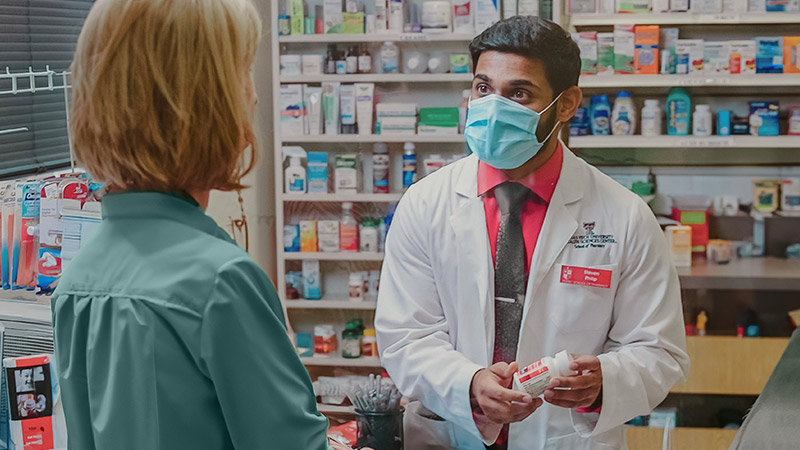 Amarillo pharmacist assisting a patient in the pharmacy