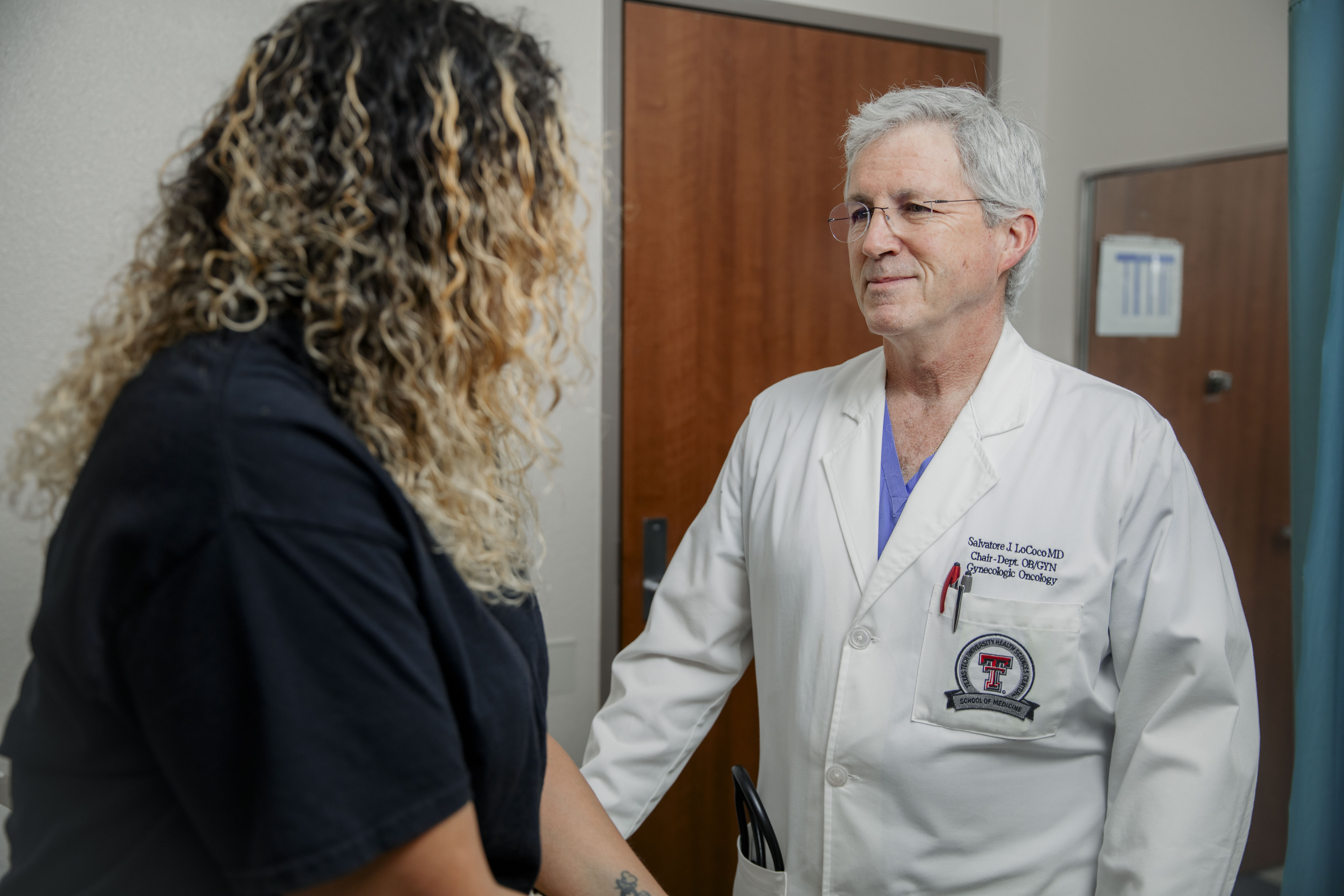 Dr. LoCoco consults with a femaie patient.