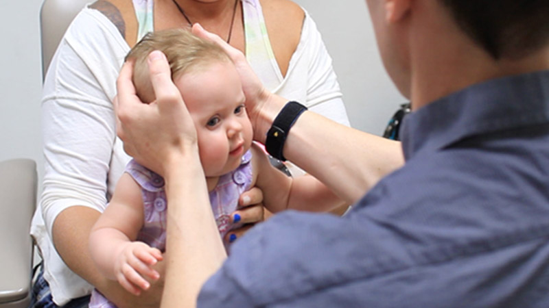 Doctor examining baby's head